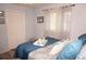 Bedroom with a queen-size bed, blue bedding, and plenty of natural light at 7100 Mineola Rd, Englewood, FL 34224