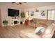 Relaxing living room with large sectional sofa and mounted TV at 7100 Mineola Rd, Englewood, FL 34224