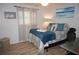 Bright bedroom with a queen-size bed and light blue walls at 7100 Mineola Rd, Englewood, FL 34224