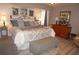 Main bedroom featuring a king-size bed and gray bedding at 7100 Mineola Rd, Englewood, FL 34224