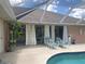Inviting pool area with lounge chairs and covered lanai at 7100 Mineola Rd, Englewood, FL 34224