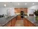 Kitchen with double sinks, granite counters and ample cabinetry at 1109 Harbour Glen Pl, Punta Gorda, FL 33983