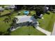 Scenic aerial view of a charming home with a spacious yard, pool, and convenient shed at 20347 Mount Prospect Ave, Port Charlotte, FL 33952