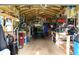 A full view of the interior of the shed, with tools, equipment, and a John Deere riding lawn mower at 20347 Mount Prospect Ave, Port Charlotte, FL 33952