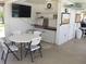 Community room with table, chairs, and TV at 26470 Rampart Blvd # 123, Punta Gorda, FL 33983