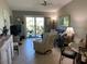 Relaxing living room with comfy seating and access to balcony at 26470 Rampart Blvd # 123, Punta Gorda, FL 33983