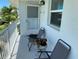 Private balcony with two chairs and small table at 26470 Rampart Blvd # 123, Punta Gorda, FL 33983