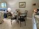Small dining area with glass table and four chairs at 26470 Rampart Blvd # 123, Punta Gorda, FL 33983