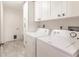 Laundry room with washer, dryer, and white cabinets at 3621 Whippoorwill Blvd, Punta Gorda, FL 33950