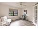 Bright home office features a glass desk, comfy couch, and large window at 3621 Whippoorwill Blvd, Punta Gorda, FL 33950