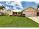 Single story home with metal roof and landscaped lawn at 3621 Whippoorwill Blvd, Punta Gorda, FL 33950