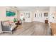 Living area with wood-look floors and views to entryway and guest bedroom at 3621 Whippoorwill Blvd, Punta Gorda, FL 33950
