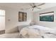 Peaceful bedroom with a queen bed, ceiling fan, and stylish artwork at 3621 Whippoorwill Blvd, Punta Gorda, FL 33950