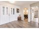Bright entryway with double doors, wood-look floors, and a view of the bathroom at 3621 Whippoorwill Blvd, Punta Gorda, FL 33950