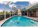 Relaxing screened pool and spa with a view of lush landscaping at 3621 Whippoorwill Blvd, Punta Gorda, FL 33950