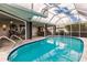 Enjoy this refreshing pool with a covered patio and open access to the interior at 3621 Whippoorwill Blvd, Punta Gorda, FL 33950