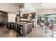 Updated kitchen featuring granite island, stainless steel appliances, and dark wood cabinets at 3621 Whippoorwill Blvd, Punta Gorda, FL 33950