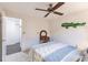 Bright bedroom with a double bed, ceiling fan, and walk-in closet at 3621 Whippoorwill Blvd, Punta Gorda, FL 33950