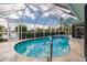 Refreshing pool with a screened enclosure and a view of the water at 3621 Whippoorwill Blvd, Punta Gorda, FL 33950