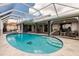 Inviting pool area with a screened enclosure, spa, and patio furniture at 3621 Whippoorwill Blvd, Punta Gorda, FL 33950