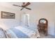 Serene bedroom with a double bed, ceiling fan, and wicker chair at 3621 Whippoorwill Blvd, Punta Gorda, FL 33950