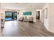 Spacious living room with wood-look floors, access to pool, and seating area at 3621 Whippoorwill Blvd, Punta Gorda, FL 33950