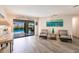 Spacious living room with wood-look floors, access to pool, and seating area at 3621 Whippoorwill Blvd, Punta Gorda, FL 33950