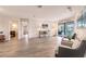 Living room with wood-look floors, access to pool, and seating area at 3621 Whippoorwill Blvd, Punta Gorda, FL 33950