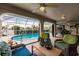 Comfortable patio furniture with views of the pool and waterfront at 3621 Whippoorwill Blvd, Punta Gorda, FL 33950