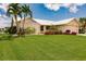 Single story home with metal roof, landscaping and lawn at 3621 Whippoorwill Blvd, Punta Gorda, FL 33950
