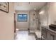 Updated bathroom with walk-in shower, granite vanity, and large mirror at 3621 Whippoorwill Blvd, Punta Gorda, FL 33950