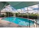 Large, screened pool with a spa and view of the marina at 3621 Whippoorwill Blvd, Punta Gorda, FL 33950