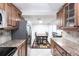 Bright kitchen features granite countertops and ample wood cabinets at 25188 Marion Ave # C301, Punta Gorda, FL 33950