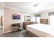 Main bedroom with king bed, desk, and ceiling fan at 25188 Marion Ave # C301, Punta Gorda, FL 33950