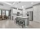 Bright kitchen boasts stainless steel appliances, island with stone accent, pendant lighting, and eat-in dining space at 16195 Maya Cir, Punta Gorda, FL 33955