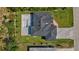 This stylish home features an in-ground pool, paved driveway, a covered patio, and a lush lawn at 212 Fairway Rd, Rotonda West, FL 33947