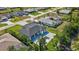 This stylish home features an in-ground pool, paved driveway, a covered patio, and a lush lawn at 212 Fairway Rd, Rotonda West, FL 33947