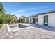 Backyard featuring an unfinished in-ground pool, brick patio and a covered patio with white columns at 212 Fairway Rd, Rotonda West, FL 33947