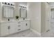 Bathroom featuring a dual sink vanity with modern lighting and fixtures at 212 Fairway Rd, Rotonda West, FL 33947