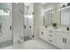 Bathroom featuring dual glass-enclosed showers, dual sink vanity, and sleek modern finishes at 212 Fairway Rd, Rotonda West, FL 33947