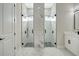 Modern bathroom with dual glass door showers, marble walls, and dual sink vanity at 212 Fairway Rd, Rotonda West, FL 33947
