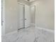 Bright bedroom with white marble floors, closet, and white baseboards at 212 Fairway Rd, Rotonda West, FL 33947