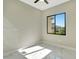 Bedroom with a black ceiling fan, marble floors, and a window overlooking the yard at 212 Fairway Rd, Rotonda West, FL 33947
