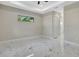 Bright bedroom features marble tile flooring, tray ceiling, recessed lighting, and a window view at 212 Fairway Rd, Rotonda West, FL 33947