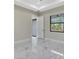 Bedroom showcasing tile floors, recessed lighting, tray ceiling, and an en suite bathroom at 212 Fairway Rd, Rotonda West, FL 33947