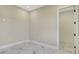 Bedroom featuring white marble floors and a white baseboard at 212 Fairway Rd, Rotonda West, FL 33947