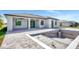 Exterior view of the back of the house featuring a covered patio, in-ground pool and brick pavers at 212 Fairway Rd, Rotonda West, FL 33947