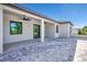 The back of the house has a covered patio and is surrounded by pavers at 212 Fairway Rd, Rotonda West, FL 33947