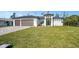 Well-maintained home with a manicured lawn, a two car garage and modern architectural features at 212 Fairway Rd, Rotonda West, FL 33947
