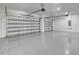 A spacious three car garage with an epoxy floor and white walls at 212 Fairway Rd, Rotonda West, FL 33947